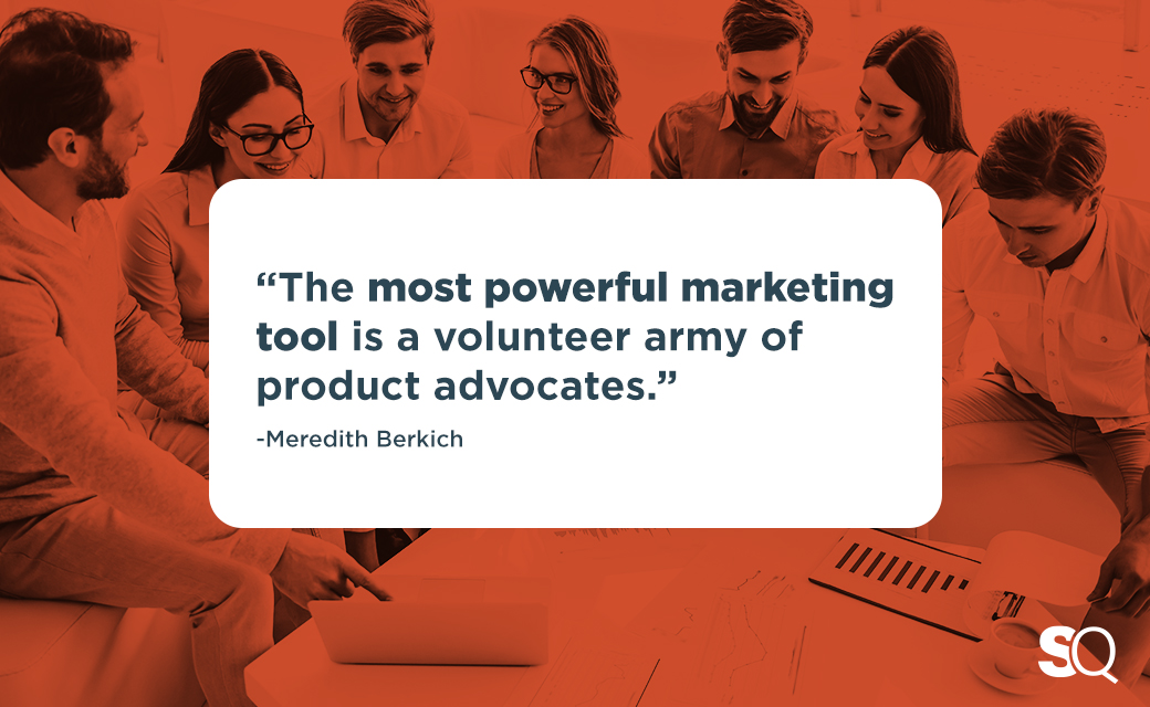 mlm team gathered around corporate table with overlay of meredith quote on volunteer army