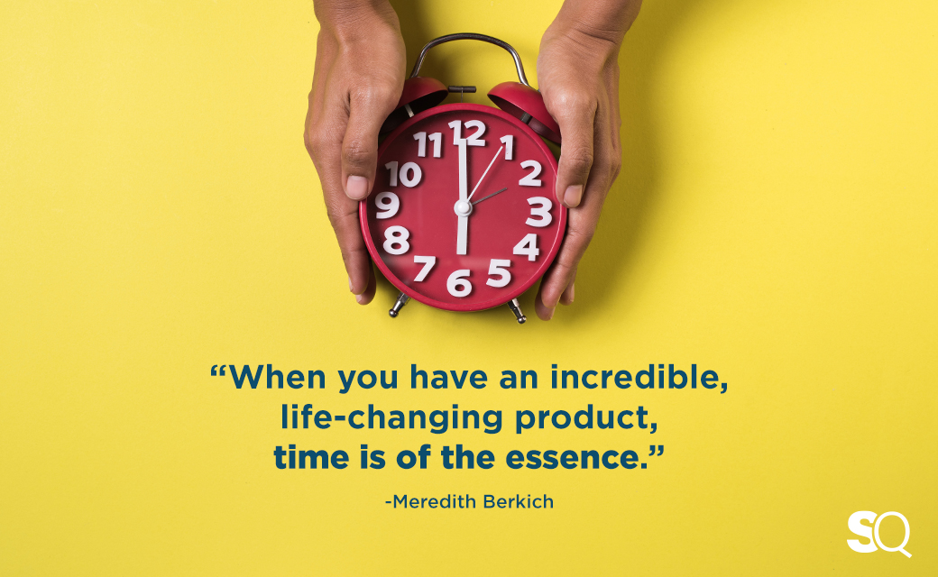 red clock in hands with overlay of meredith quote on essence of time when launching a product
